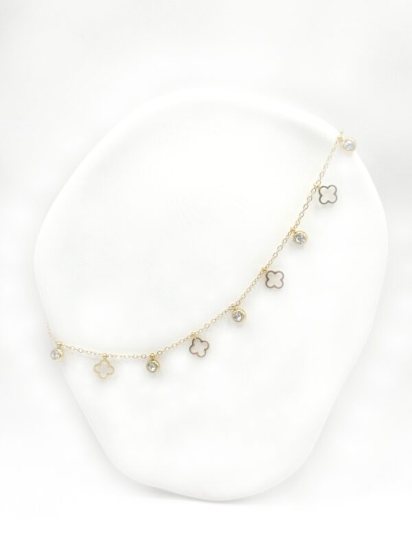 Gold stainless steel necklace with decorative elements and sparkling zircon stones. An elegant and timeless design for any occasion.